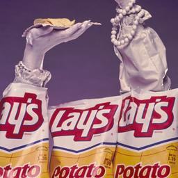 Hands emerging from chip bags.