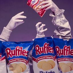 Hands emerging from chip bags.