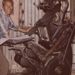 Two men working with printi...