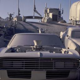 Gray vehicles on undulating...