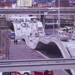 Gray vehicles on undulating...