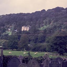 Cemetery with large house o...
