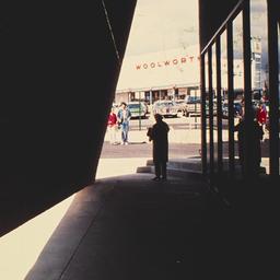 Exterior view, people stand...