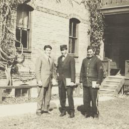 Three Men Standing in front...