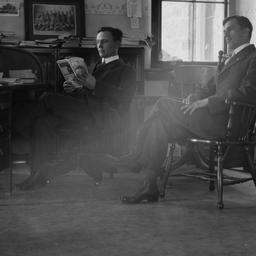 Two Men Sitting in a Office...
