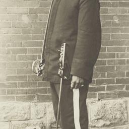 Young Man in Uniform Holdin...