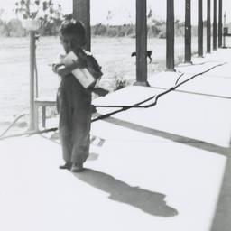 Small Boy Standing on a Porch