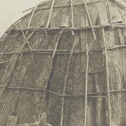 Woman next to a Wickiup