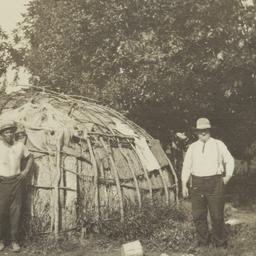 Two Men in Front of Wickiup
