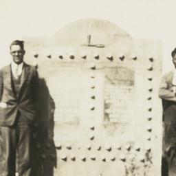 Two Men Standing next to a ...