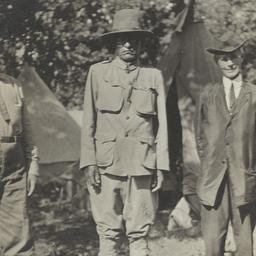 Three Men Standing Outdoors...