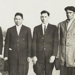 Four Men Standing in a Fiel...