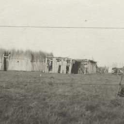Two Thatched and Wooden Str...