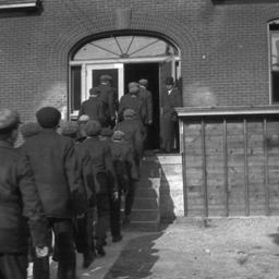 Group of Men Entering a Bui...