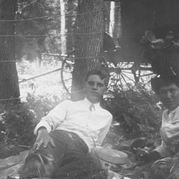 Two Men Lying next to a Wir...
