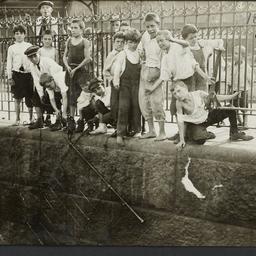 Boys Against Iron Fence