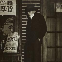 Young Man Huddled Against a...