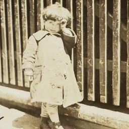 Child Beside a Wooden Fence