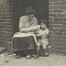 Woman Feeding Child
