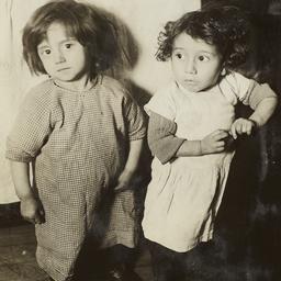 Two Little Girls near Bed