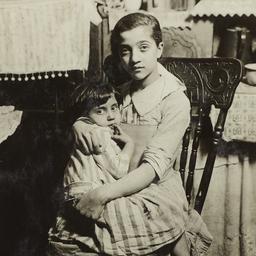 Girl holding Child on Chair