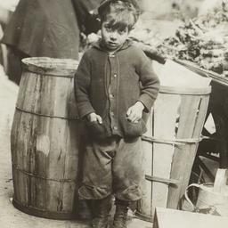 Boy near Barrels and Pushcart