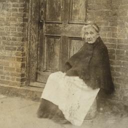 Old Woman Sitting near Door