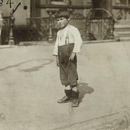 Boy Standing on Sidewalk