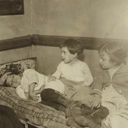 Woman with Children on Bed
