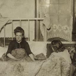 Woman in Bed with Two Children