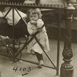 Girl Leaning on Wrought Iro...