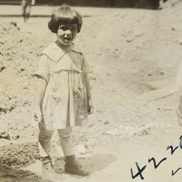 Girl near Mound of Dirt
