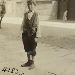 Child on Sidewalk with Hand...