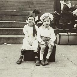 Children Sitting on Suitcase