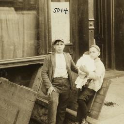 Two Boys with Baby on Sidewalk