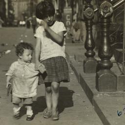 Girl Holding Hand of Small ...