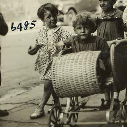 Girl Pushing Boy in Pram