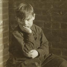 Boy Sitting on Crate
