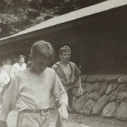 Boys Walking next to Cabin