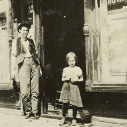 Man and Girl in Front of Shop