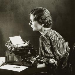 Woman Writing on Typewriter
