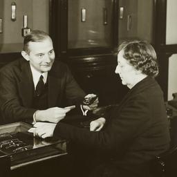 Man Showing Glasses to Woman