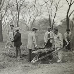 Men Clearing Area with Whee...