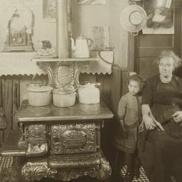 Woman with Girl near Stove