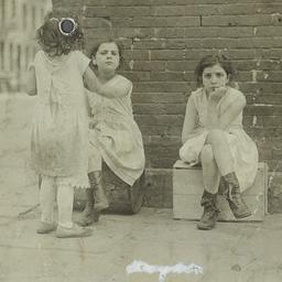 Girl On Box Next to Two Girls
