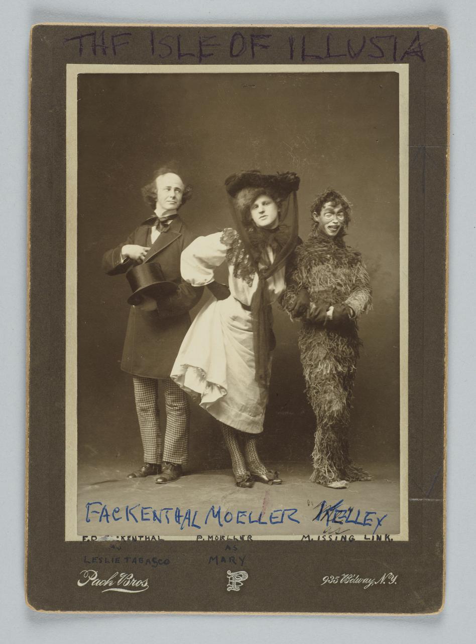 Photo of three cast members of Isle of Illusia Varsity Show. Man in top hat, a man dressed as a woman and a man in an animal costume.