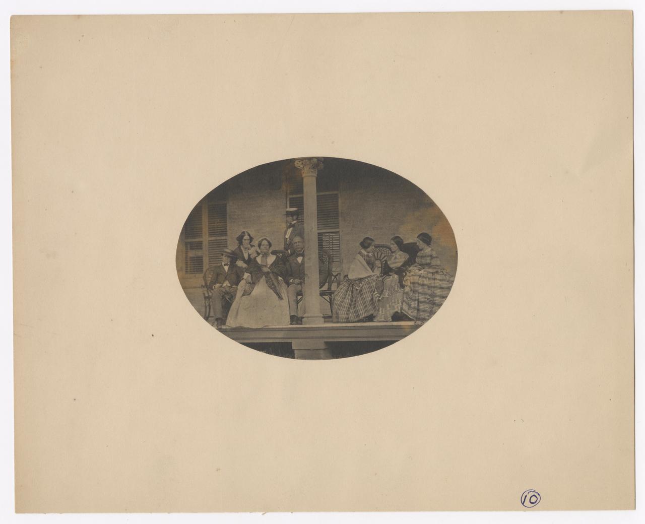 Group of eight people on a porch.