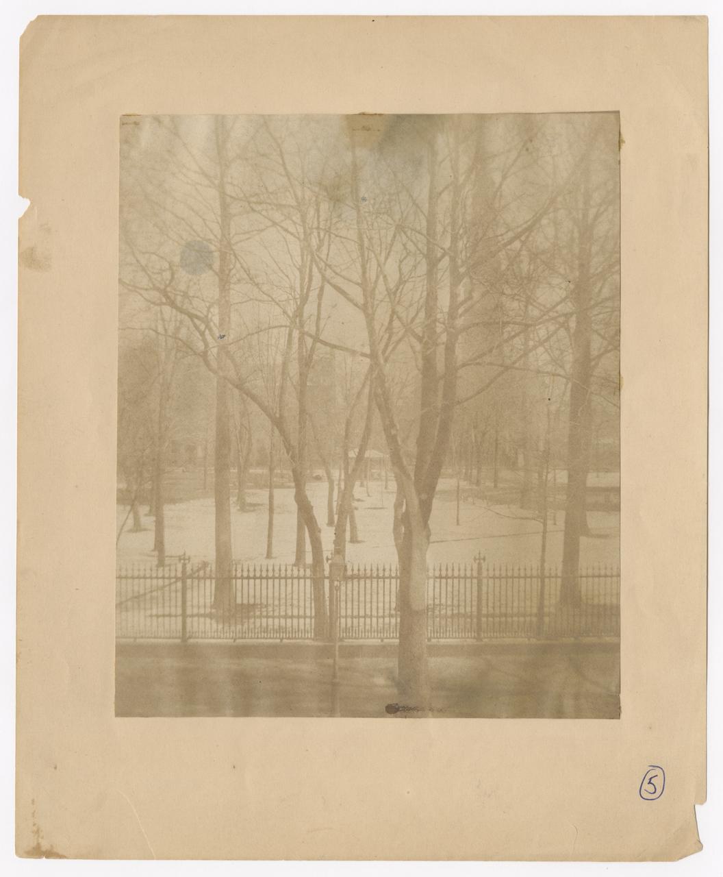 View of St. John's Chapel and park in the winter with snow on the ground.