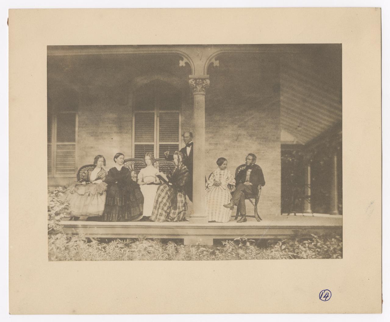 Group of seven on a porch.