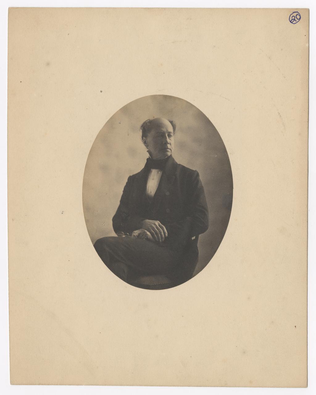 William Moore sits with his hand crossed on his lap.